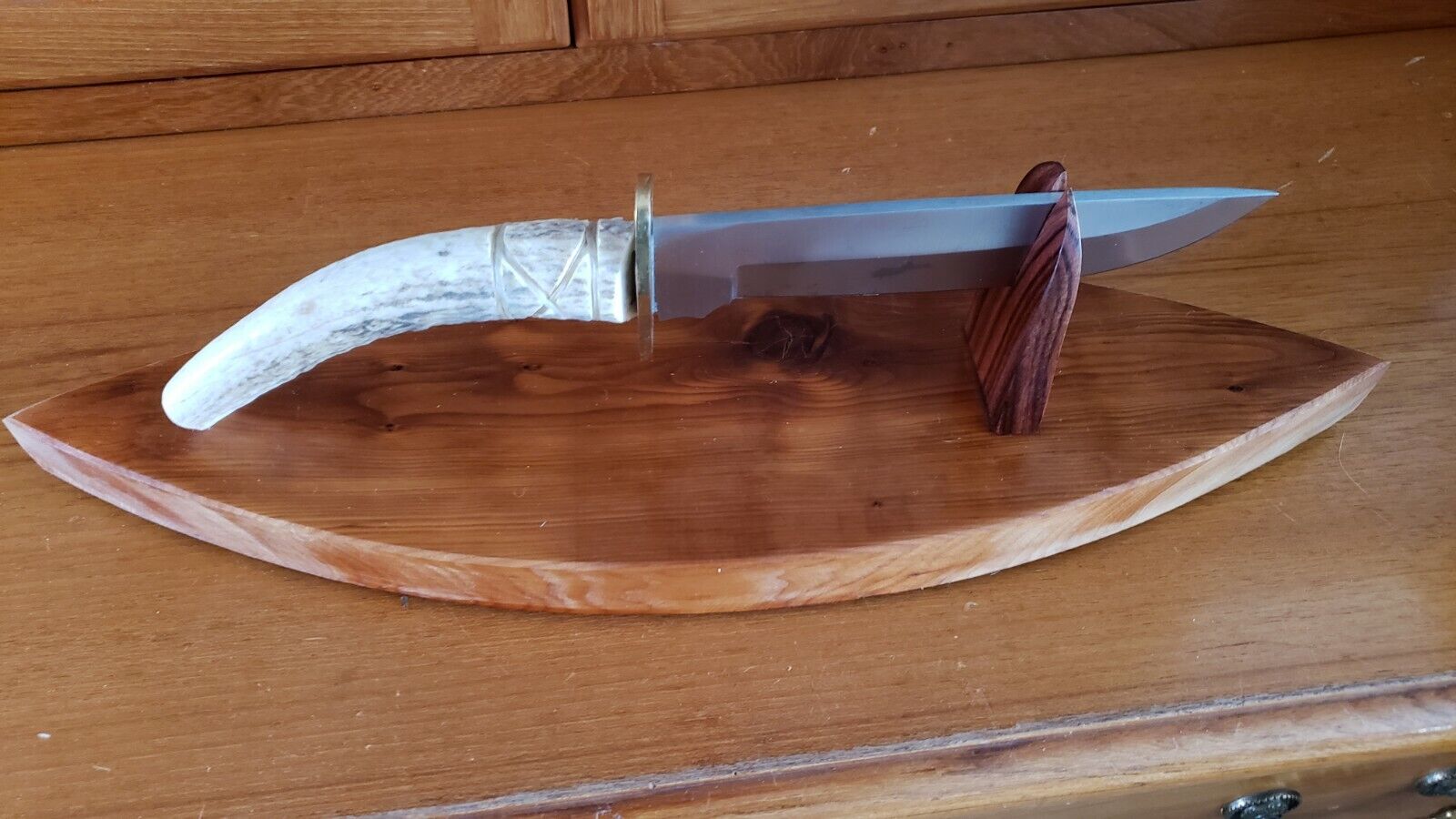 7 Inch Stainless Blade 6 Inch Antler Handle.  18 Inch 5 Inch Wide Maple Base